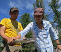 Researcher Sanaa Byambasuren and geographer Amy Hessl holding a section of a tree